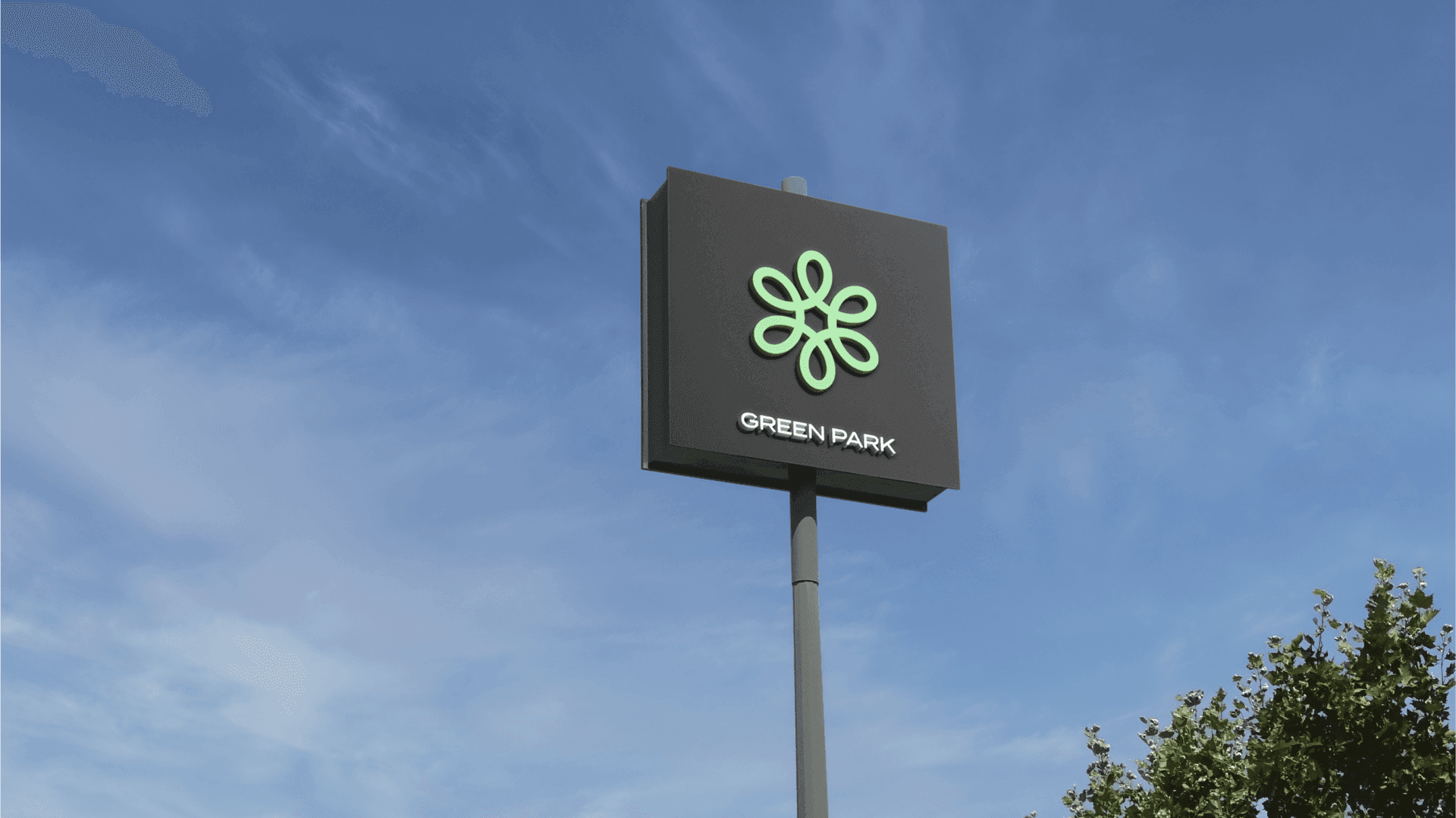 Green Park Logo on a signpost, sky and a tree in the background